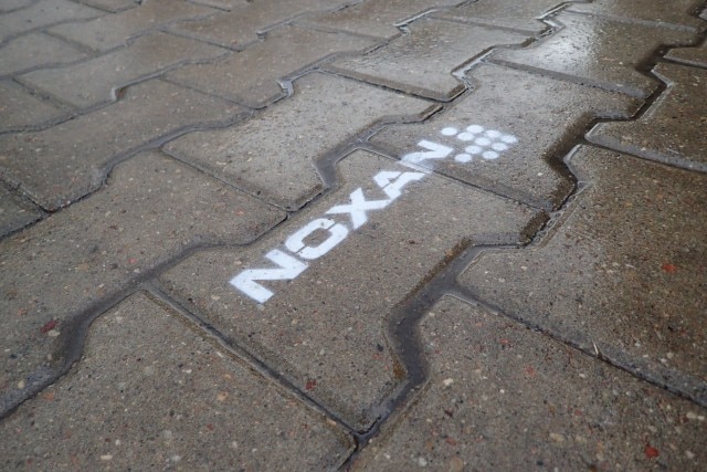 Wymalowany znak przy pomocy sprayu na kostce brukowej